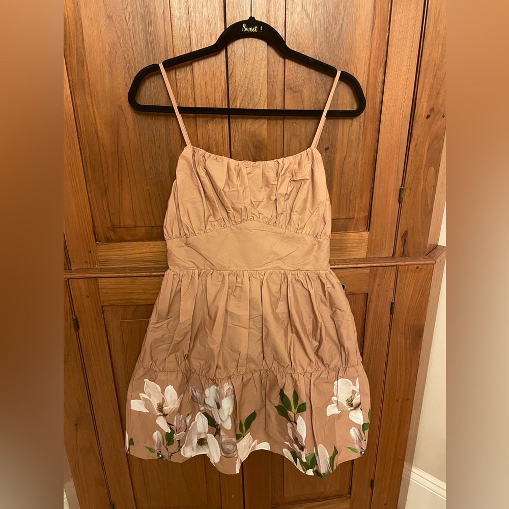 Tan Express Dress with a Flower Design at the Bottom